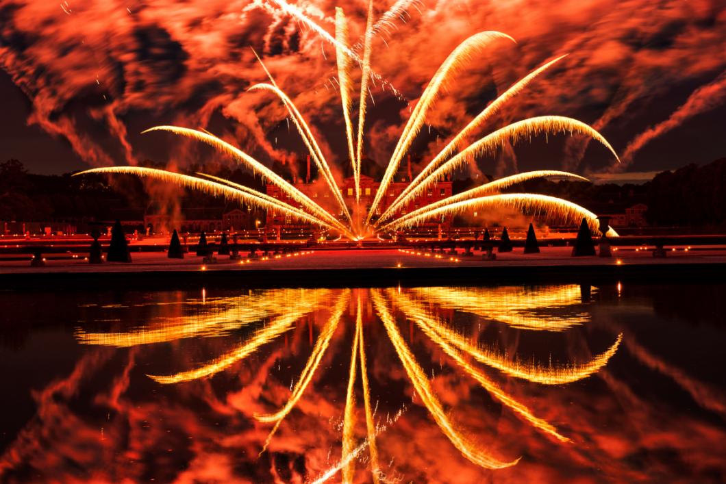 Evoking France’s grand siècle (great century), the Chateau de Vaux-le-Vicomte blushes with a crimson glow as a semicircle of fireworks arc across the garden and reflects in the pool below. PHOTO BY DIANE COOK AND LEN JENSHEL; MAINCY, FRANCE<br />

