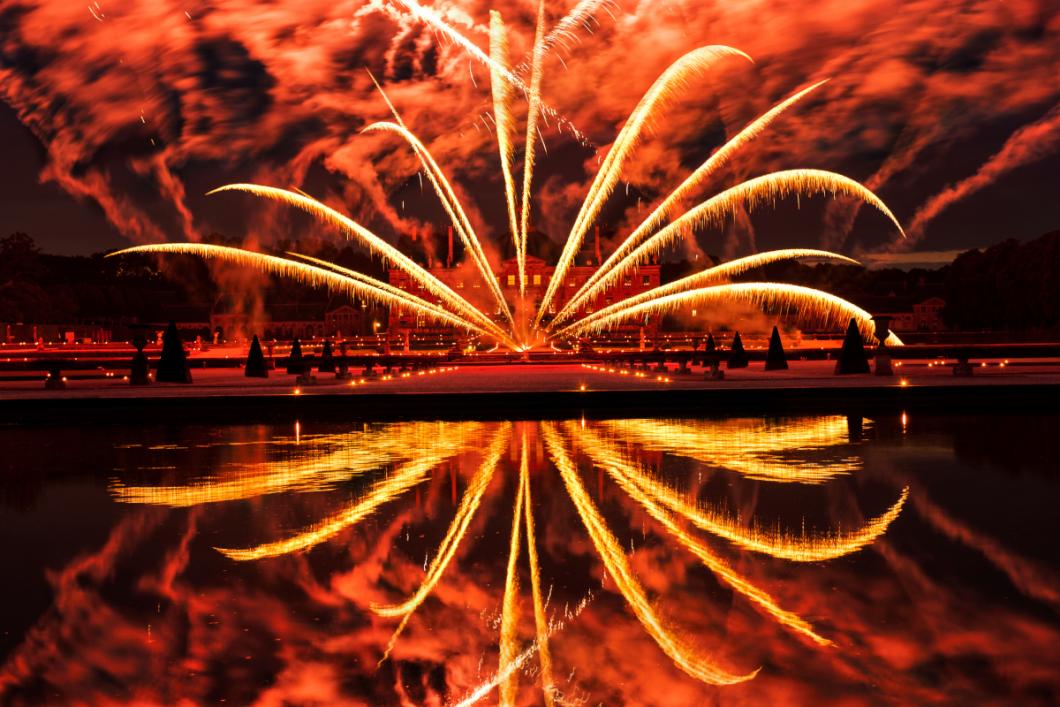 Evoking France’s grand siècle (great century), the Chateau de Vaux-le-Vicomte blushes with a crimson glow as a semicircle of fireworks arc across the garden and reflects in the pool below. PHOTO BY DIANE COOK AND LEN JENSHEL; MAINCY, FRANCE<br />
